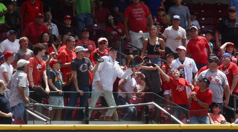 A fan catches a home run hit by the Rockies against the Reds on Wednesday, June 21, 2023, at Great American Ball Park in Cincinnati. David Jablonski/Staff
