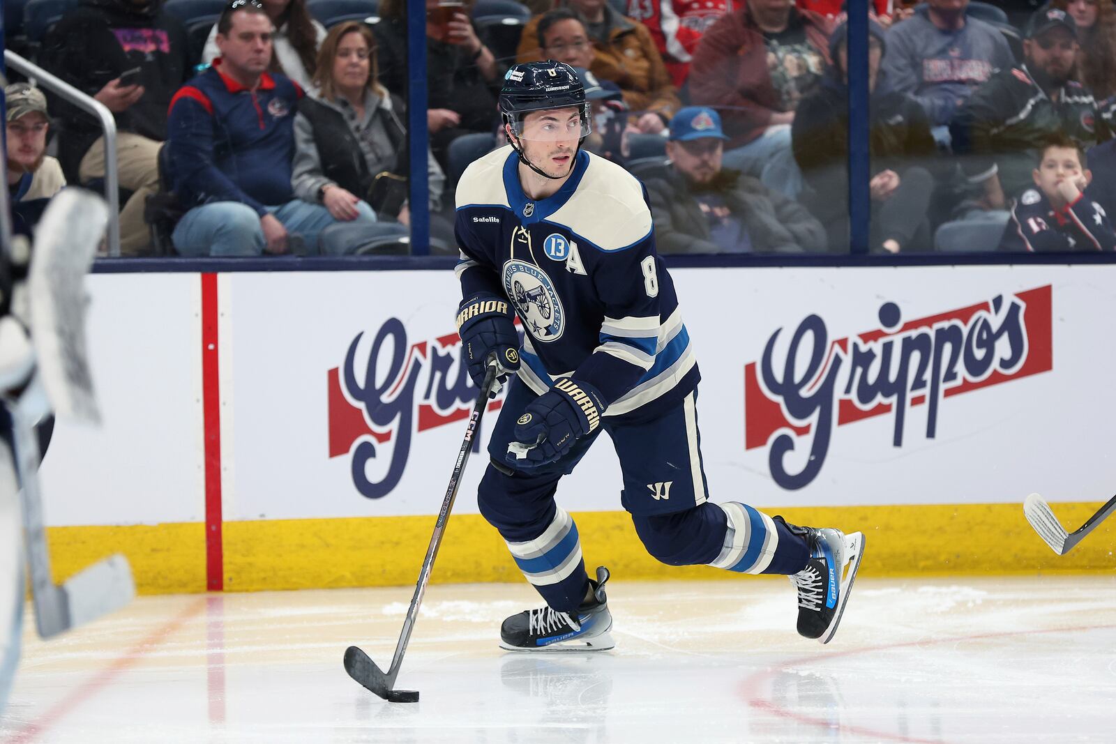 Columbus Blue Jackets defenseman Zach Werenski (8) controls the puck during the third period of an NHL hockey game against the Washington Capitals on Saturday, April 12, 2025, in Columbus, Ohio. (AP Photo/Joe Maiorana)