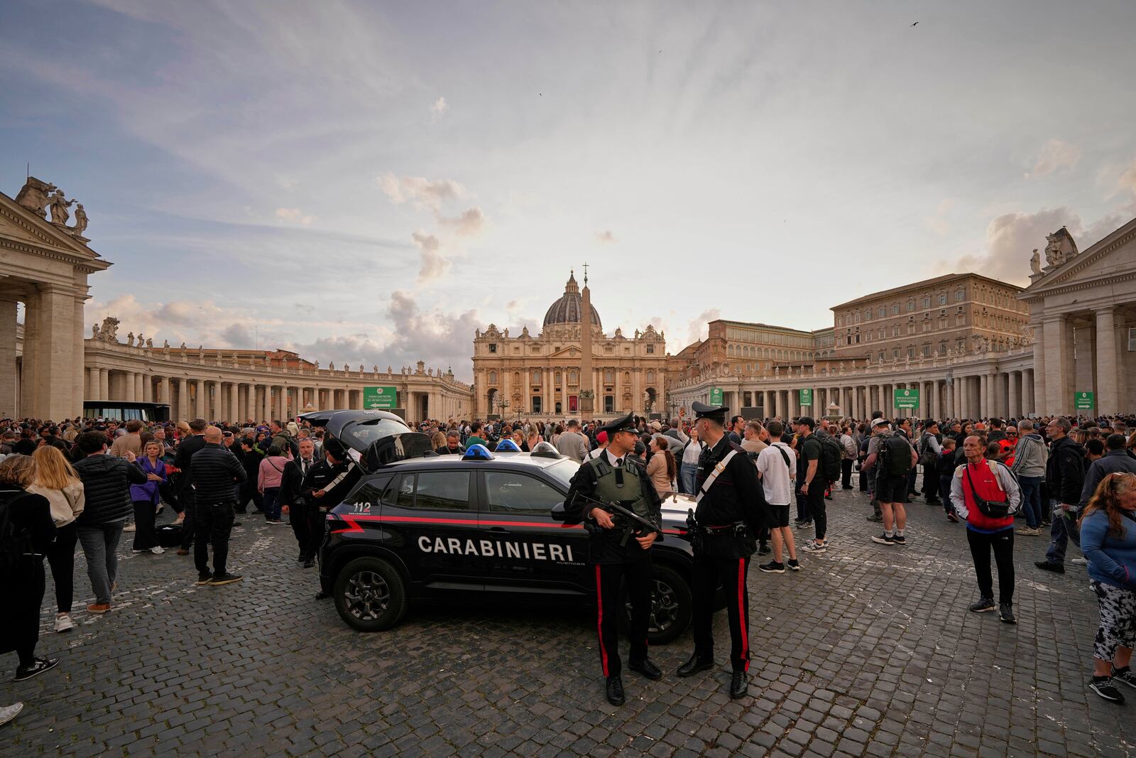 People wait in St. Peter's Square to pay their respects to the late Pope Francis, who will lie in state at St. Peter's Basilica for three days, at the Vatican, Wednesday, April 23, 2025. (AP Photo/Andreea Alexandru)