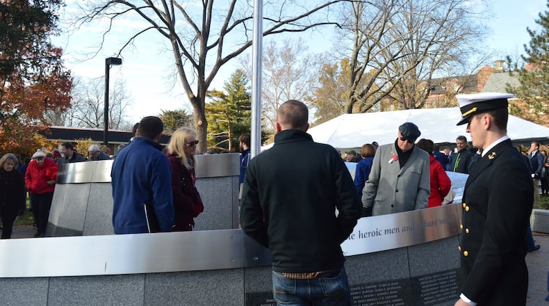 Visitors moved quickly for a closer viewing of the Miami University Alumni Veterans Tribute following the end of the formal dedication ceremony Nov. 11, to read the names and quotes up close and share in the experience. CONTRIBUTED/BOB RATTERMAN