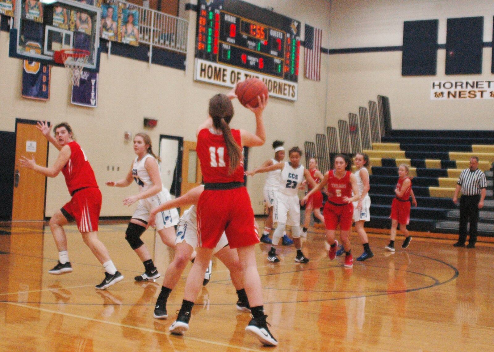 South Charleston Southeastern’s Lily Hudson (11) prepares to make a pass to teammate Trinity Cline (14) during Wednesday night’s Division IV sectional game at Monroe. Defending for Cincinnati Christian are Lauren Barr (44) and Caila Nagel, who’s in front of Hudson. Southeastern won 40-12. RICK CASSANO/STAFF