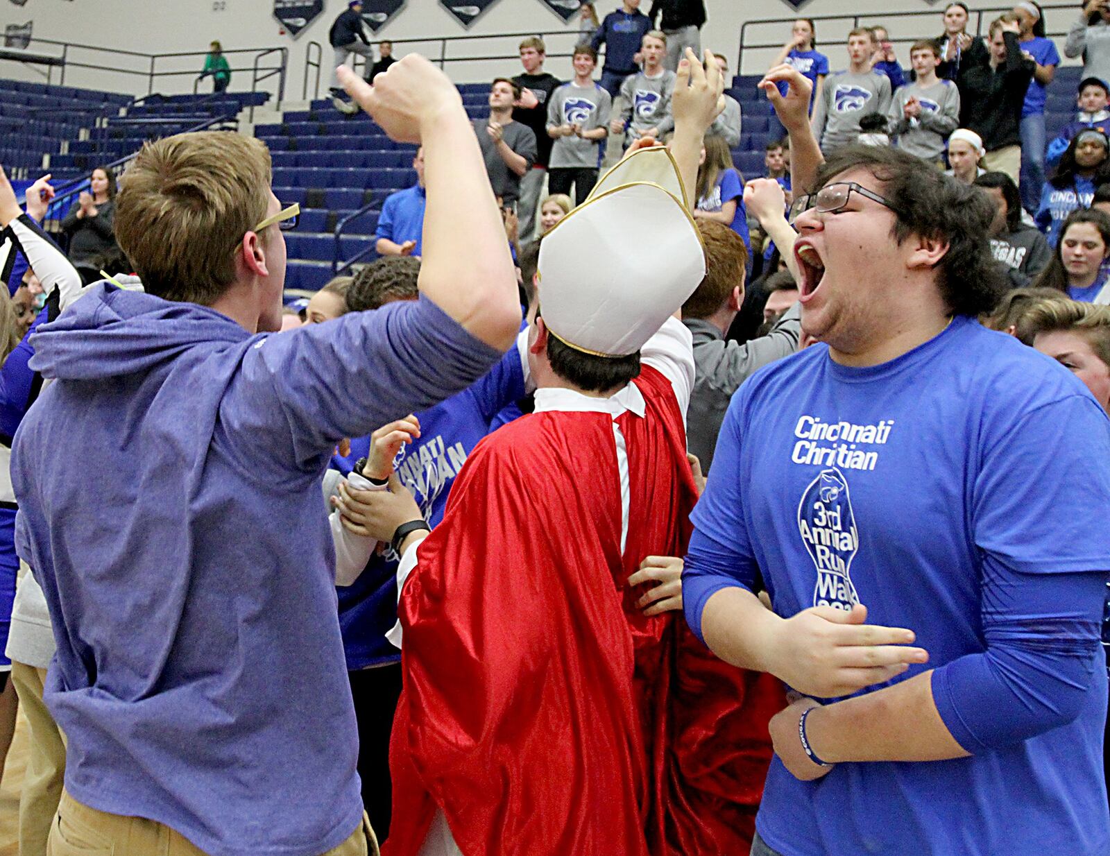 Cincinnati Christian students celebrate Tuesday night after the Cougars secured their first-ever Division IV regional win over New Madison Tri-Village at Fairmont’s Trent Arena. CONTRIBUTED PHOTO BY E.L. HUBBARD