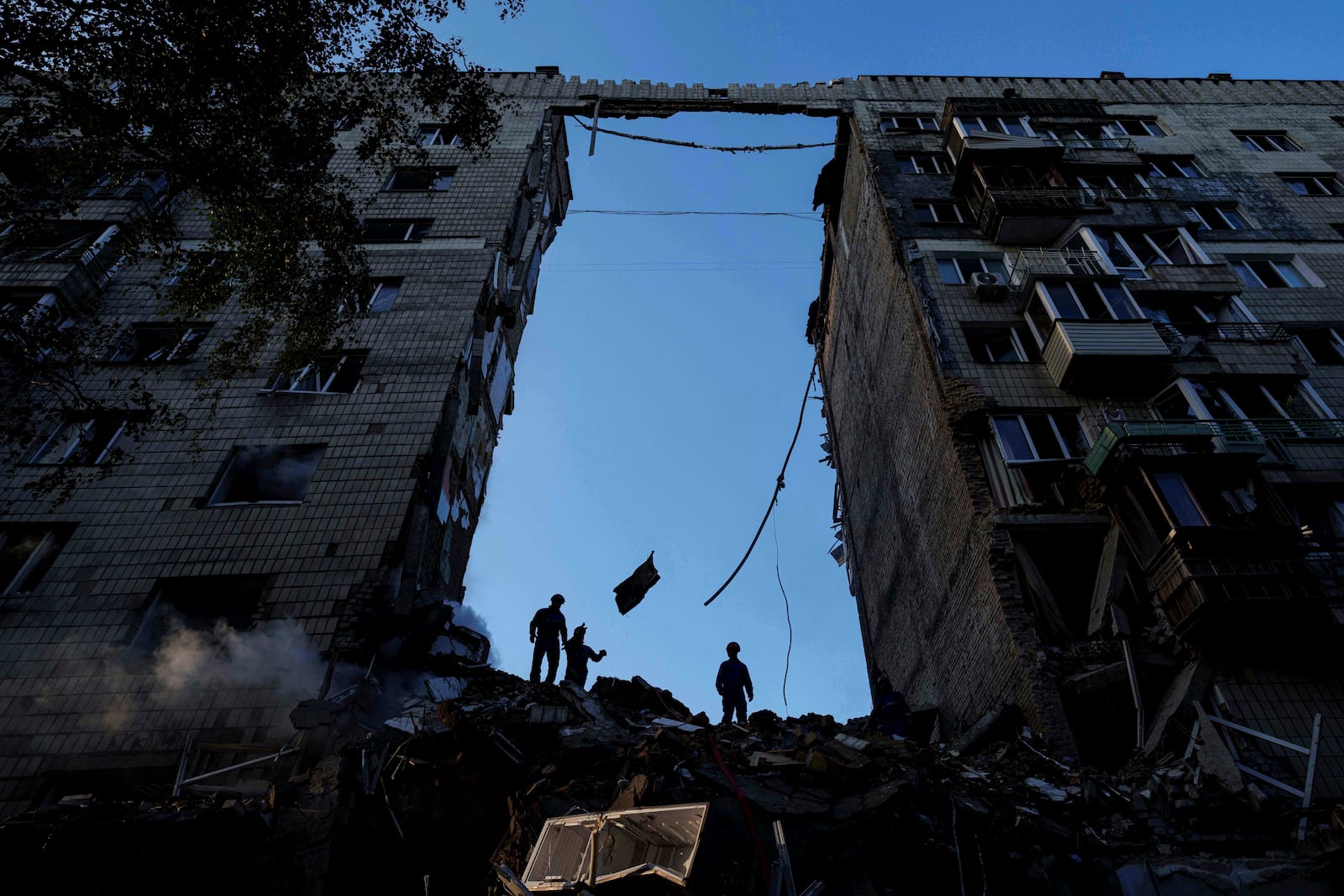 Rescue workers clear the rubble of a multi-storey residential house destroyed by a Russian strike in Kyiv, Ukraine, on Tuesday, June 17, 2025. (AP Photo/Evgeniy Maloletka)