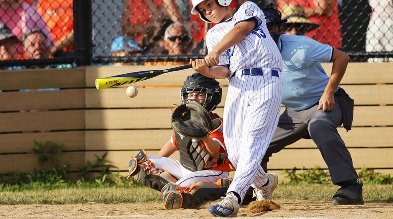 Hamilton's Maddox Jones makes contact with the ball during Hamilton West Side Little League's 10-1 win over Loveland in the District 9 Little League championship Monday, July 11, 2022 at Home of the Brave Park in Loveland. NICK GRAHAM/STAFF6