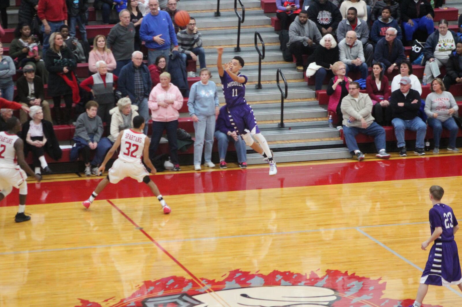 Middletown’s Cliff Snow puts up the last shot of the game as Lima Senior’s Marquis Coleman defends Friday night at Lima. CONTRIBUTED PHOTO BY MARITZA MCKINNEY