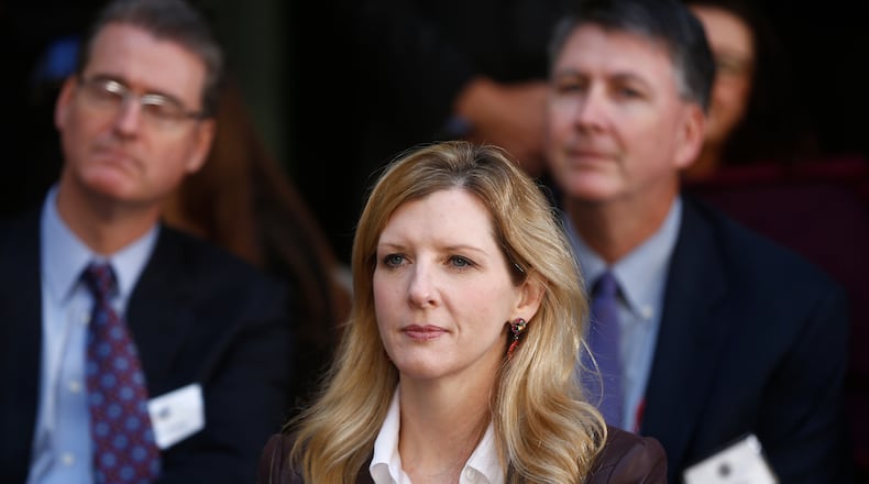 FILE - White House counsel Kathryn Ruemmler listens as President Barack Obama speaks at an installation ceremony for FBI Director James Comey at FBI Headquarters, in Washington, Oct. 28, 2013. (AP Photo/Charles Dharapak, File)