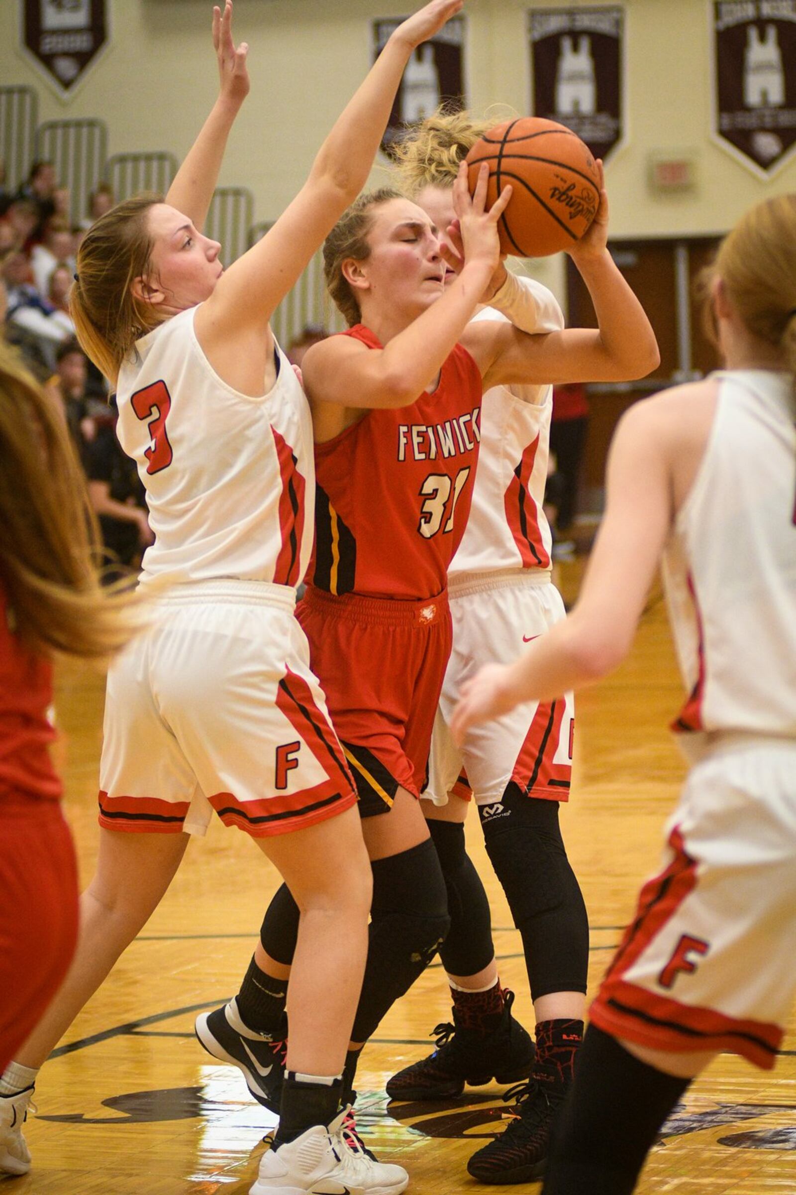 Fenwick’s Emily Adams (31) handles the ball in traffic as Franklin’s Kaylee Harris (3) defends during Monday night’s Division II district basketball semifinal at Lebanon. Franklin won 47-35. ROB MCCULLEY/RAM PHOTOGRAPHY