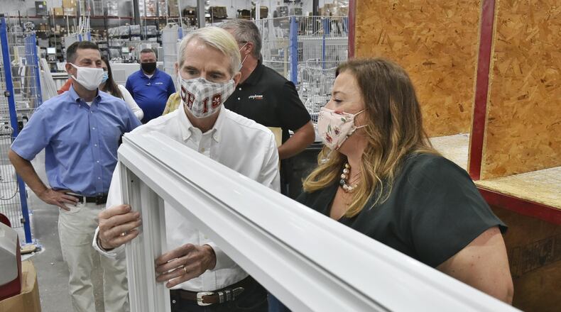 U.S. Sen. Rob Portman, R-Cincinnati, talks with Vinylmax Windows president Laura Doeger-Roberts as he tours the Hamilton plant Monday, August 31, 2020. Vinylmax is one of the local business who received a payroll protection program loan to keep their employees on payroll during the COVID-19 pandemic. NICK GRAHAM / STAFF