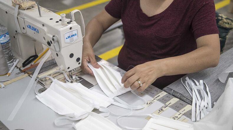 Angelica Caballero creates face masks out of fabric at Echota Fabrics, Inc. in Calhoun on April 8, 2020. Echota Fabrics, Inc. normally produces fabrics for curtains and bedding. The company’s response to the COVID19 pandemic was to create makeshift medical gowns and fabric face masks to assist healthcare workers. They are working with a local fabric manufacturer that is creating medical composite gown materials for the gowns. (ALYSSA POINTER / ALYSSA.POINTER@AJC.COM)