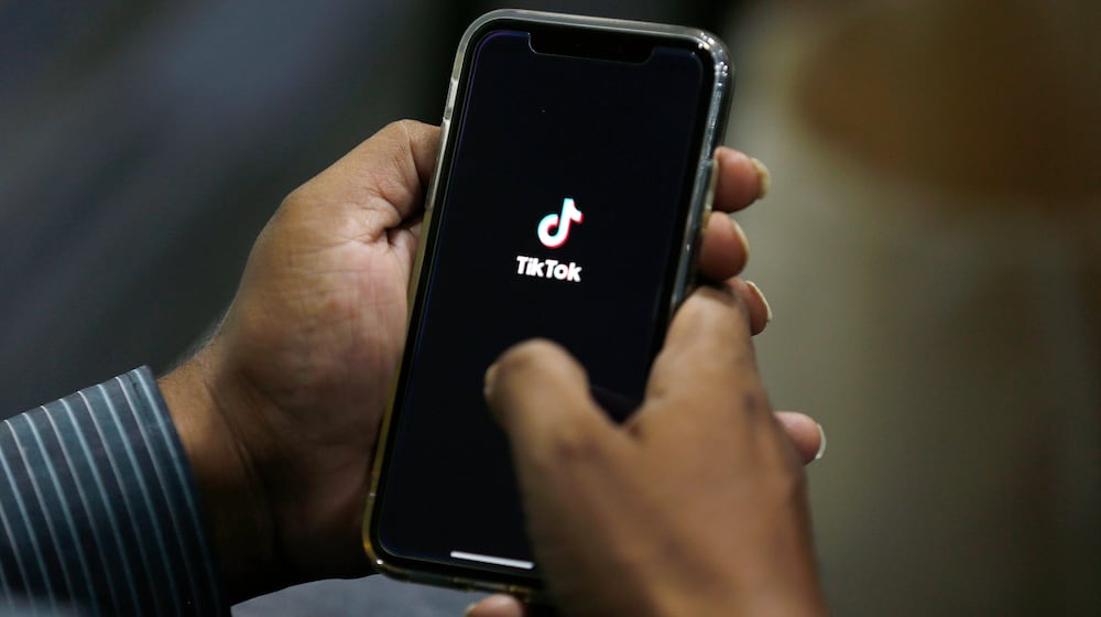 FILE - In this July 21, 2020 file photo, a man opens social media app 'TikTok' on his cell phone, in Islamabad, Pakistan. (AP Photo/Anjum Naveed, File)