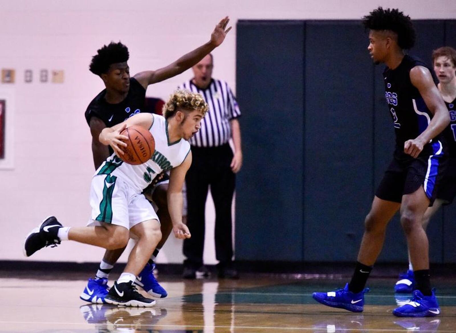 New Miami’s Trey Robinette dribbles into the Cincinnati Christian defense during a game Dec. 14, 2018, at New Miami. CCS won 70-52. NICK GRAHAM/STAFF