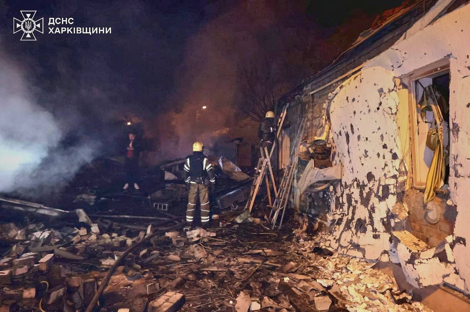 In this photo provided by the Ukrainian Emergency Service, emergency services personnel work to extinguish a fire following a Russian attack in Kharkiv, Ukraine, Saturday, May 3, 2025. (Ukrainian Emergency Service via AP)