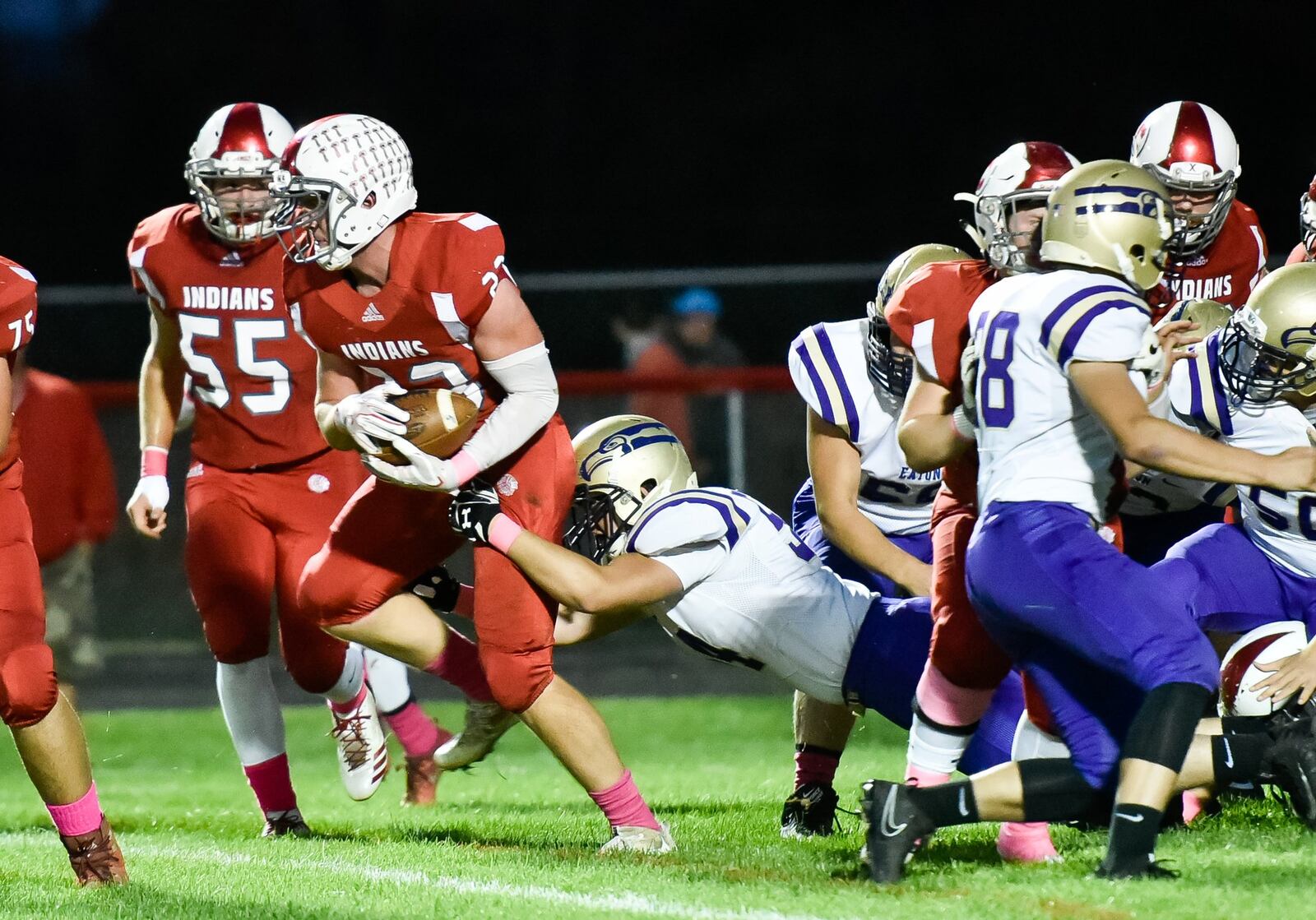 Carlisle’s Spencer Mays carries the ball through the Eaton defense during Thursday night’s game at Laughlin Field in Carlisle. NICK GRAHAM/STAFF