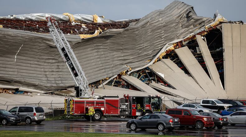 Firefighters are shown near the damage at the Meijer Distribution Center in Tipp City near Interstate 75 after a tornado struck the area on Wednesday, June 8, 2022. JIM NOELKER/STAFF