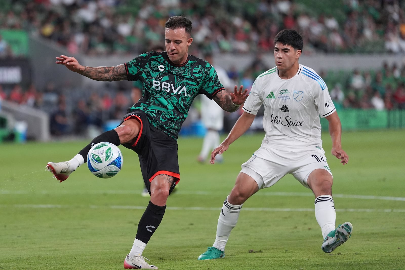 Liga MX All-Stars' Gustavo Ferraris, left, moves the ball past MLS All-Stars' Obed Vargas, right, during the MLS All-Star soccer match in Austin, Texas, Wednesday, July 23, 2025. (AP Photo/Eric Gay)