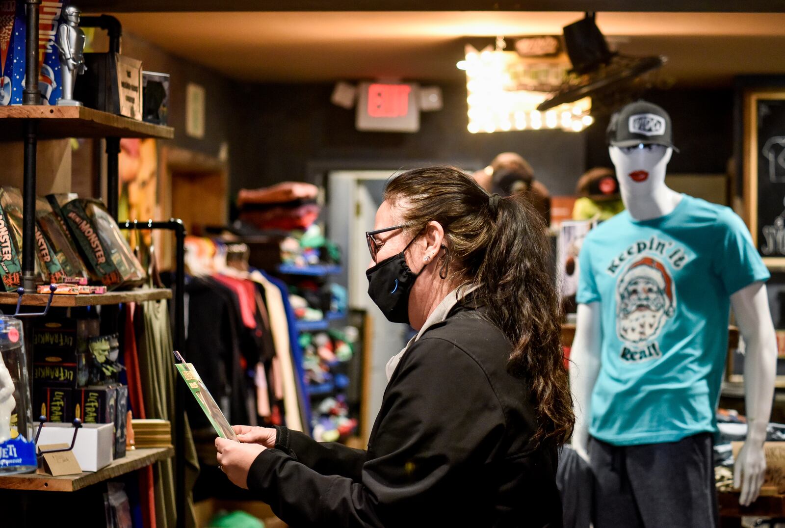 Angie Mantell-Smith wears a mask as she shops at Unsung Salvage Design Company Tuesday, Dec. 15, 2020 on Main Street in Hamilton. NICK GRAHAM / STAFF