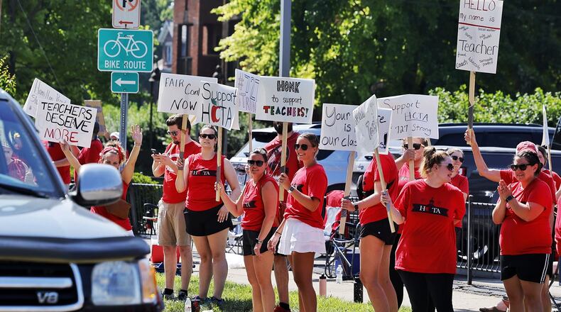 Hamilton teachers gathered along Dayton Street in front of the Hamilton City School District building to demonstrate for fair pay for teachers Wednesday, June 22, 2022. NICK GRAHAM/STAFF