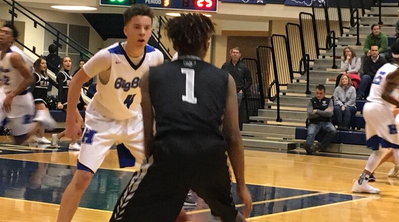 Hamilton’s Jaylen Robinson guards Lakota East’s Jalen Peck (1) during Friday night’s game at the Hamilton Athletic Center. RICK CASSANO/STAFF