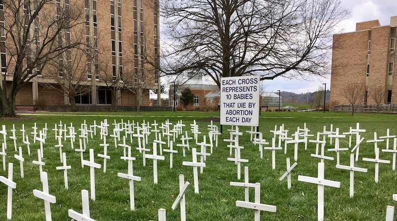A Miami University student was captured on video Monday destroying an anti-abortion display during the class day. A video shows a Miami University Hamilton campus student trampling and tossing white crucifixes — representing aborted babies — in a grassy commons area in the center of the regional school’s grounds. MICHAEL D. CLARK/STAFF