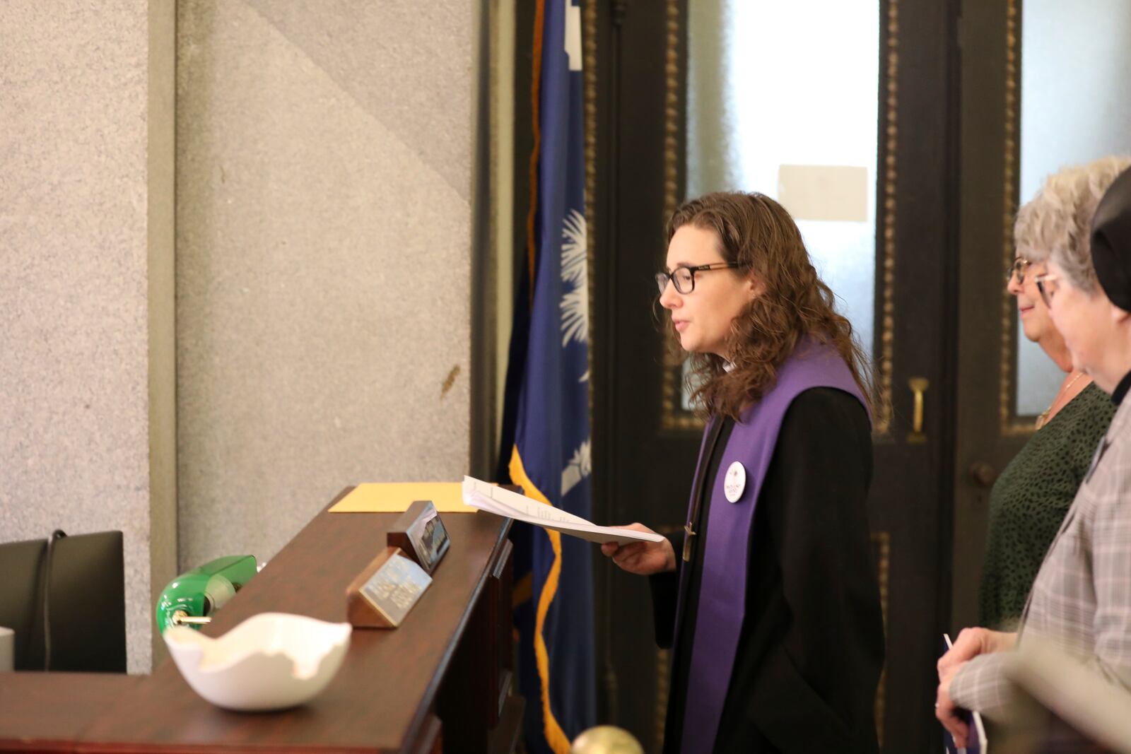South Carolinians for Alternatives to the Death Penalty Executive Director Hillary Taylor presents petitions to South Carolina Gov. Henry McMaster asking him to grant clemency to Mikal Mahdi before his firing squad execution after a news conference on Thursday, April 10, 2025, in Columbia, S.C. (AP Photo/Jeffrey Collins)