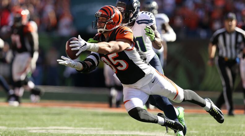 CINCINNATI, OH - OCTOBER 11: Tyler Eifert #85 of the Cincinnati Bengals dives to make a catch while being defended by Kam Chancellor #31 of the Seattle Seahawks during overtime at Paul Brown Stadium on October 11, 2015 in Cincinnati, Ohio. Cincinnati defeated Seattle 27-24 in overtime. (Photo by Andy Lyons/Getty Images)