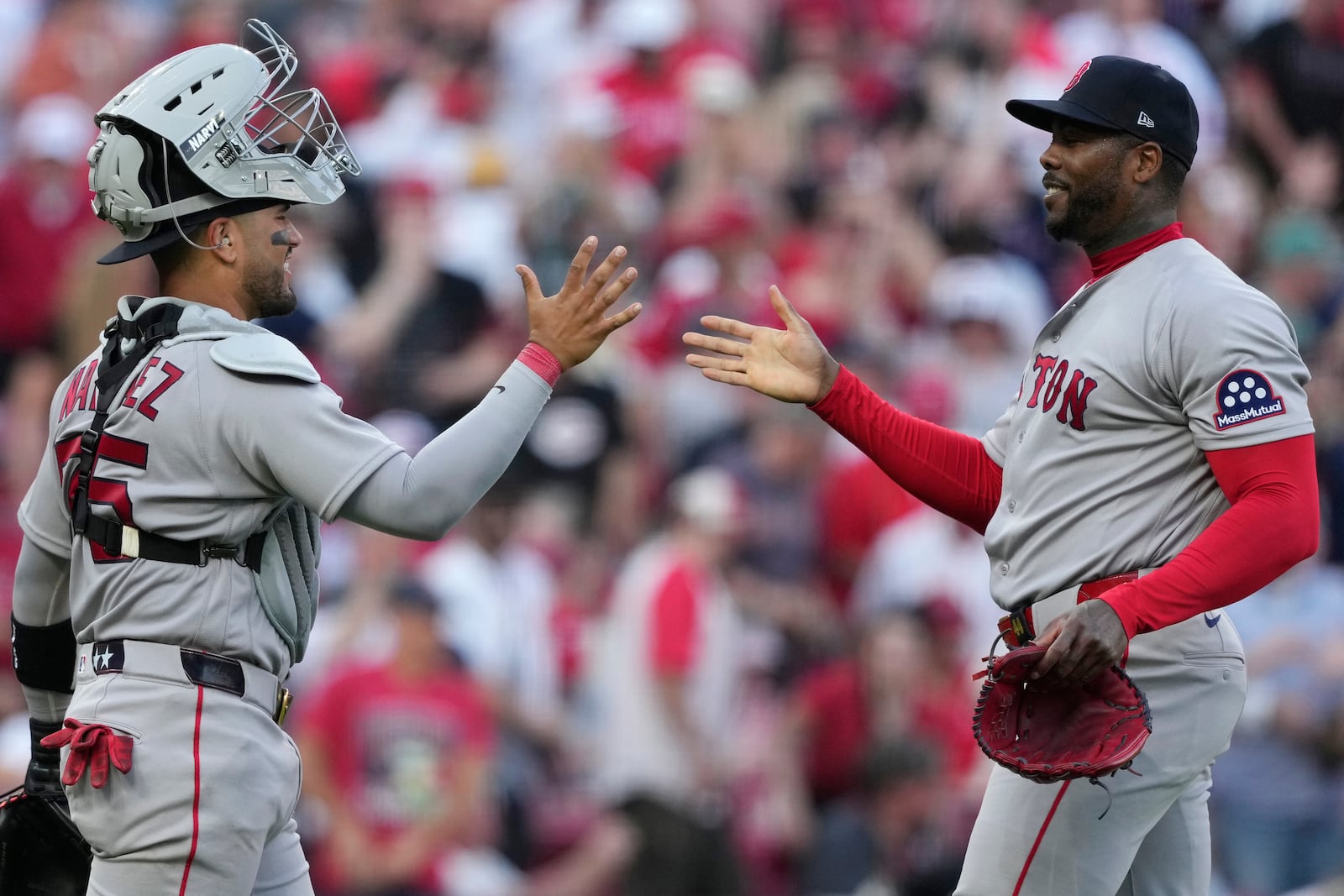 Boston Red Sox pitcher Aroldis Chapman, right, celebrates with catcher Carlos Narváez after winning an opening-day baseball game against the Cincinnati Reds in Cincinnati, Thursday, March 26, 2026. (AP Photo/Carolyn Kaster)