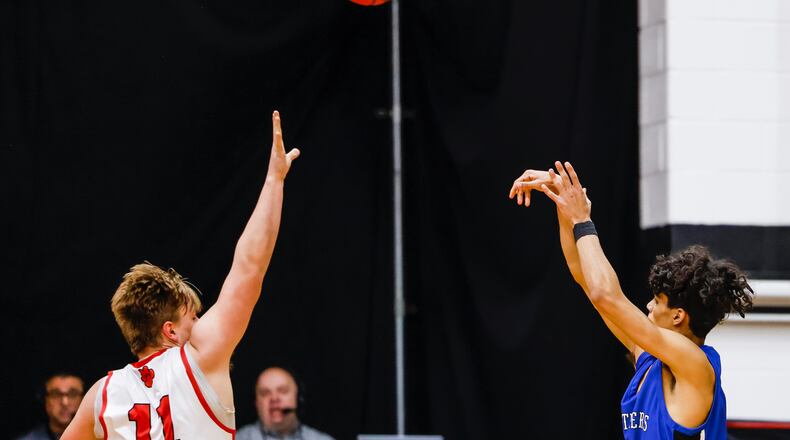 Franklin's Pierce Baulerle tries to block a shot by Springboro's RJ Greer (14) during their basketball game Tuesday, Feb. 1, 2022 at Franklin High School. Springboro won 81-71. NICK GRAHAM/STAFF