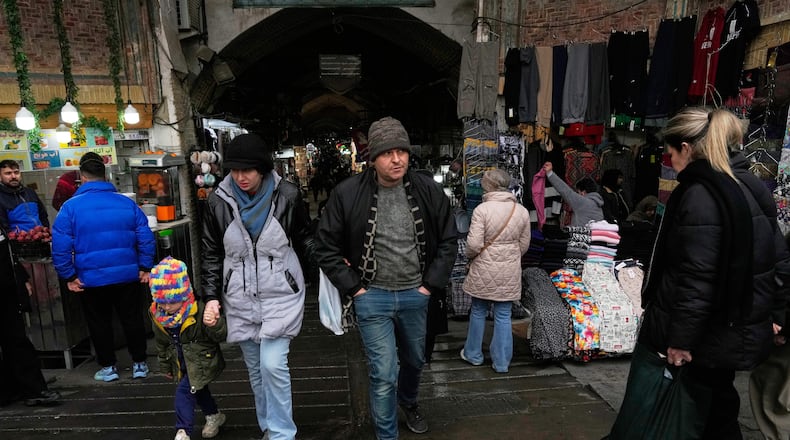 People walk at Tehran's historic Grand Bazaar, Tuesday, Jan. 20, 2026, in Iran. (AP Photo/Vahid Salemi)