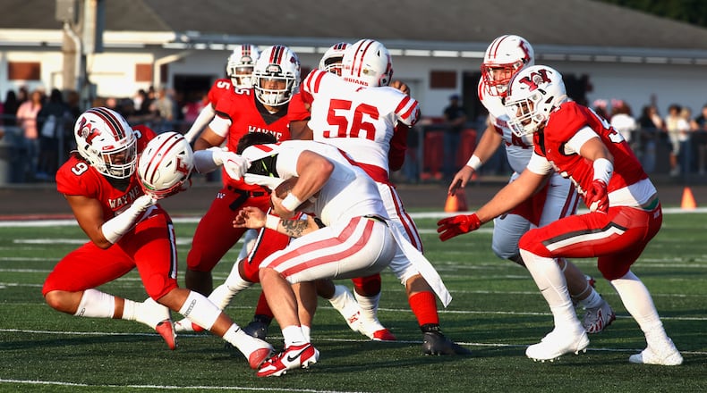 Wayne's Javon Hammonds comes away with a helmet during a tackle of Fairfield's Talon Fisher on Friday, Aug.18, 2023, at Heidkamp Stadium in Huber Heights. David Jablonski/Staff