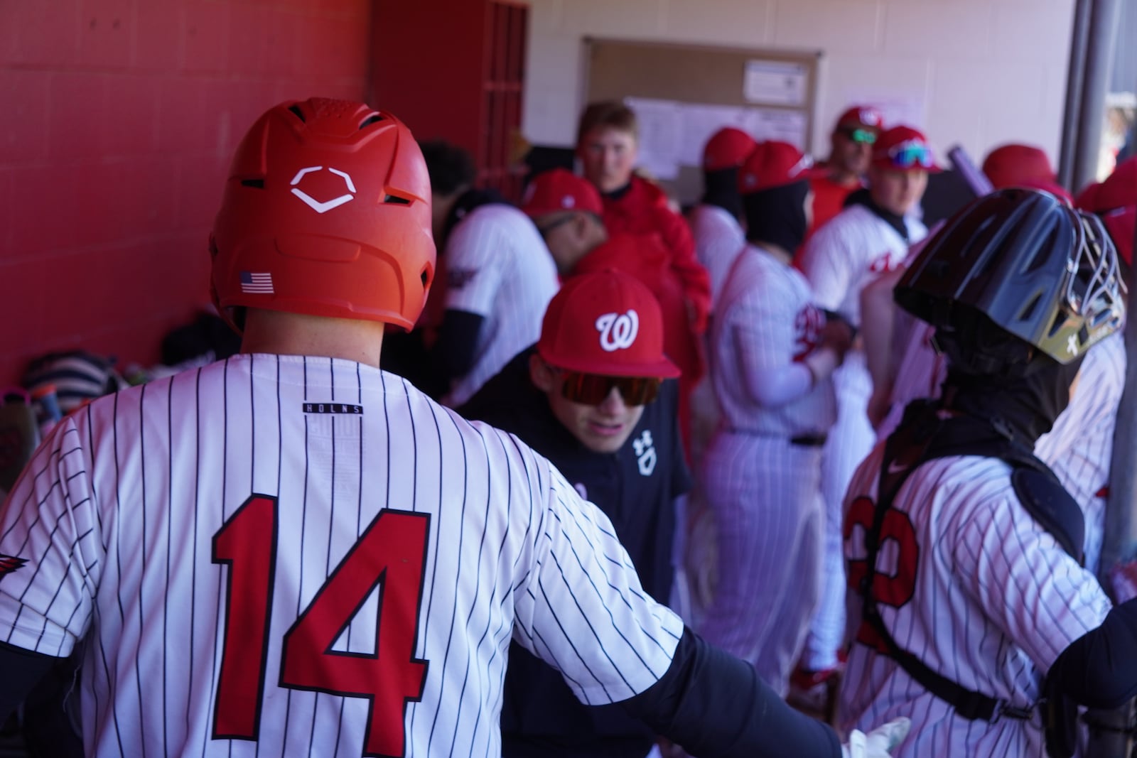 Lakota West's Tyler Zimmerman (14) enters the dugout after knocking in a run against Milford on Saturday. CHRIS VOGT / CONTRIBUTED