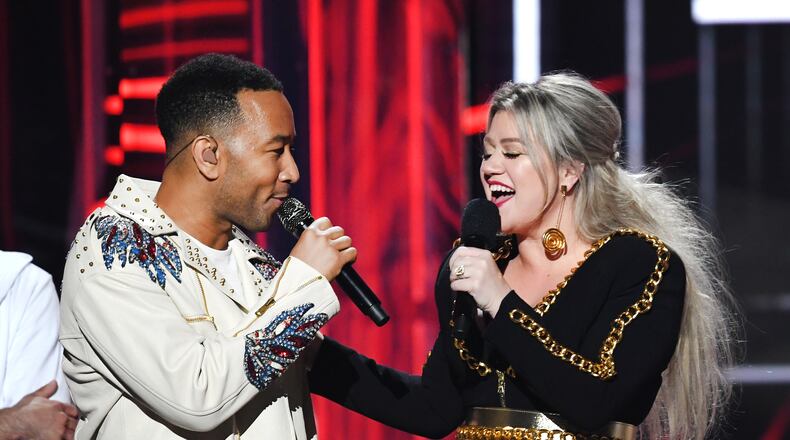 LAS VEGAS, NV - MAY 20:  Recording artist John Legend (L) and host Kelly Clarkson speak onstage during the 2018 Billboard Music Awards at MGM Grand Garden Arena on May 20, 2018 in Las Vegas, Nevada.  (Photo by Kevin Winter/Getty Images)