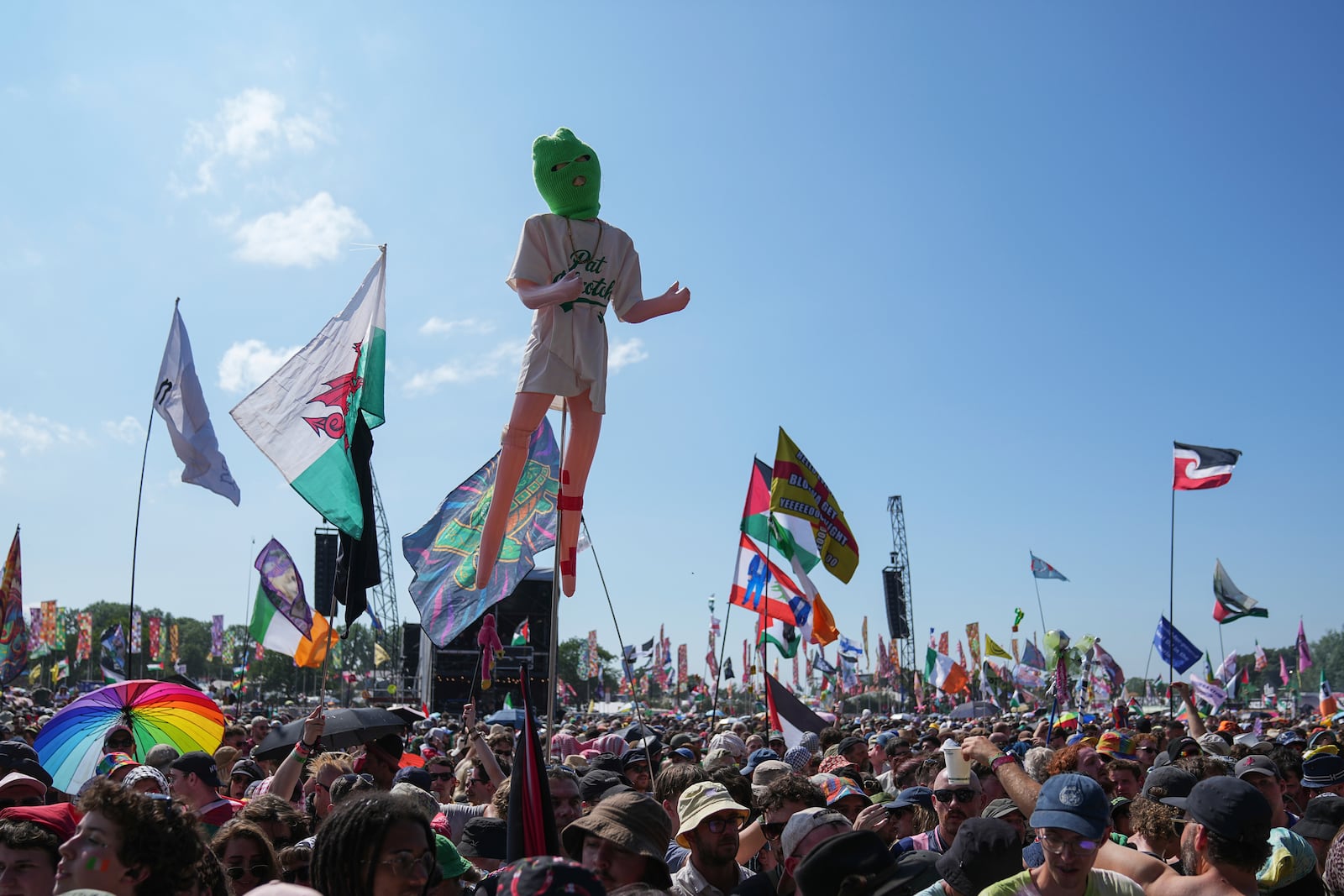 Festivalgoers wait for hip hop trio Kneecap to perform during the Glastonbury Festival in Worthy Farm, Somerset, England, Saturday, June 28, 2025. (Scott A Garfitt/Invision/AP)