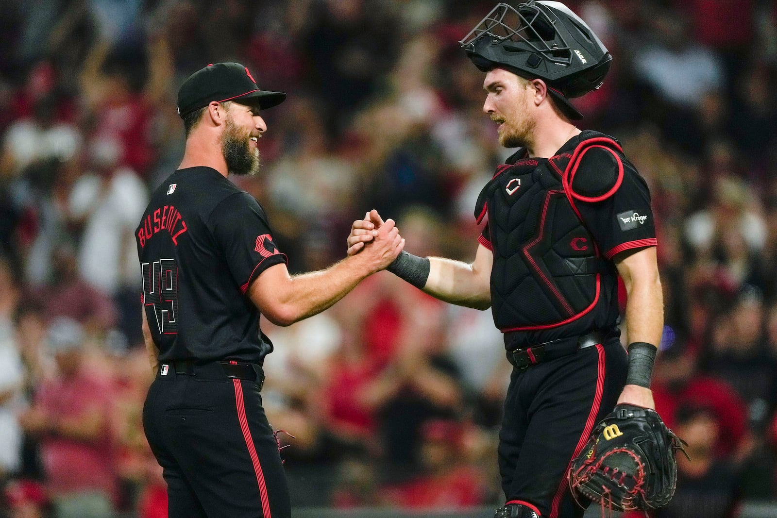 Cincinnati Reds pitcher Alan Busenitz, left, celebrates with Cincinnati Reds catcher Tyler Stephenson, right, after a baseball game against the Pittsburgh Pirates, Friday, Sept. 20, 2024, in Cincinnati. (AP Photo/Carolyn Kaster)