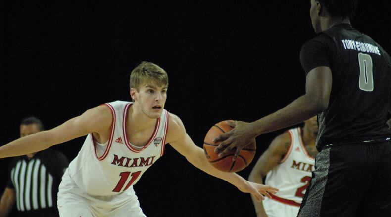 Miami's Billy Smith defends Daniel Egbuniwe of Arkansas Little Rock during Saturday's game at Millett Hall. Chris Vogt/CONTRIBUTED