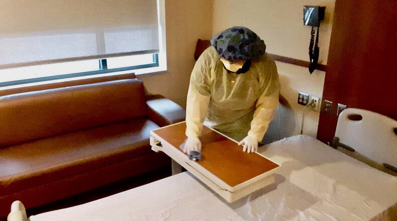 High school student Arizona McCray is among a dozen Butler Tech healthcare science students who are joining medical front-liners in helping to battle the spread of coronavirus. McCray - shown here in her personal protective equipment (PPE) - works as part of the maintenance crew cleaning up the emergency room and other patient areas at Middletown’s Atrium Medical Center. (Provided Photo/Journal-News)