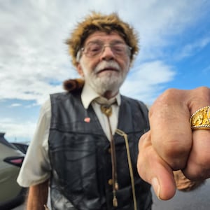 Donald Wenzel shows off is President Trump ring as he waits in line for a Trump visit at Verst Logistics Wednesday, March 11, 2026 in Hebron, Kentucky. NICK GRAHAM/STAFF