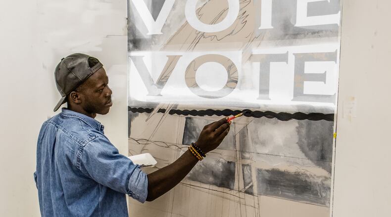 In honor of his mother Dayton photographer Bill Franz is posting a voting related image to his Facebook page, "Dayton at Work and Play," through Nov. 3. Betty Franz died Aug. 28 of Covid-19. She had planned to vote in this year's election. This image features artist Bk Elias painting at K12 Gallery. Franz added VOTE to the painting Elias was working on.