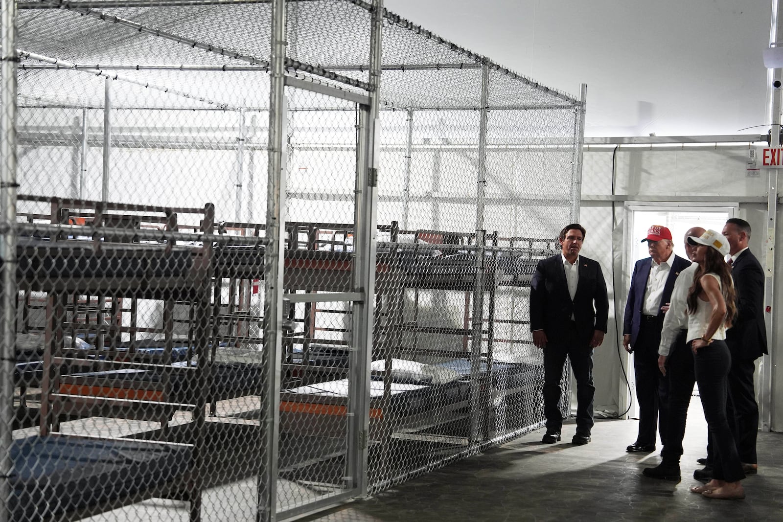 President Donald Trump, Gov. Ron DeSantis, R-Fla., and Homeland Security Secretary Kristi Noem, and others, tour "Alligator Alcatraz," a new migrant detention facility at Dade-Collier Training and Transition facility, Tuesday, July 1, 2025, in Ochopee, Fla. (AP Photo/Evan Vucci)