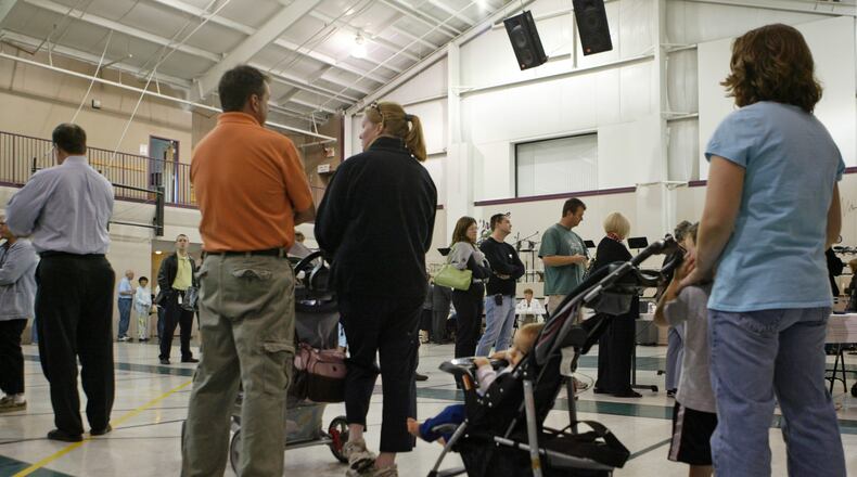 In 2008, voters from three different precincts waited in lines at Grace Baptist Church in Mason to cast their ballots on election day. FILE