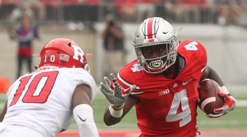 Ohio State’s Curtis Samuel tries to avoid a tackle against Rutgers’ Blessuan Austin on Saturday, Oct. 1, 2016, at Ohio Stadium in Columbus. David Jablonski/Staff