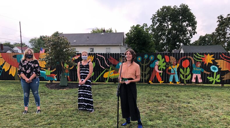 Residents of the Jefferson neighborhood gathered in August to celebrate a new mural, Garden Parade, in the two-year-old Jefferson Park. The mural's designer and main painter, Lizzy DuQuette, is shown speaking. On Saturday, a new Hamilton program called 'Coffee with Council' will start in the same park. MIKE RUTLEDGE/STAFF