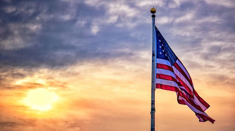 Flag in Monroe with morning sunrise. NICK GRAHAM / STAFF @grahamfoto @butlercoohio