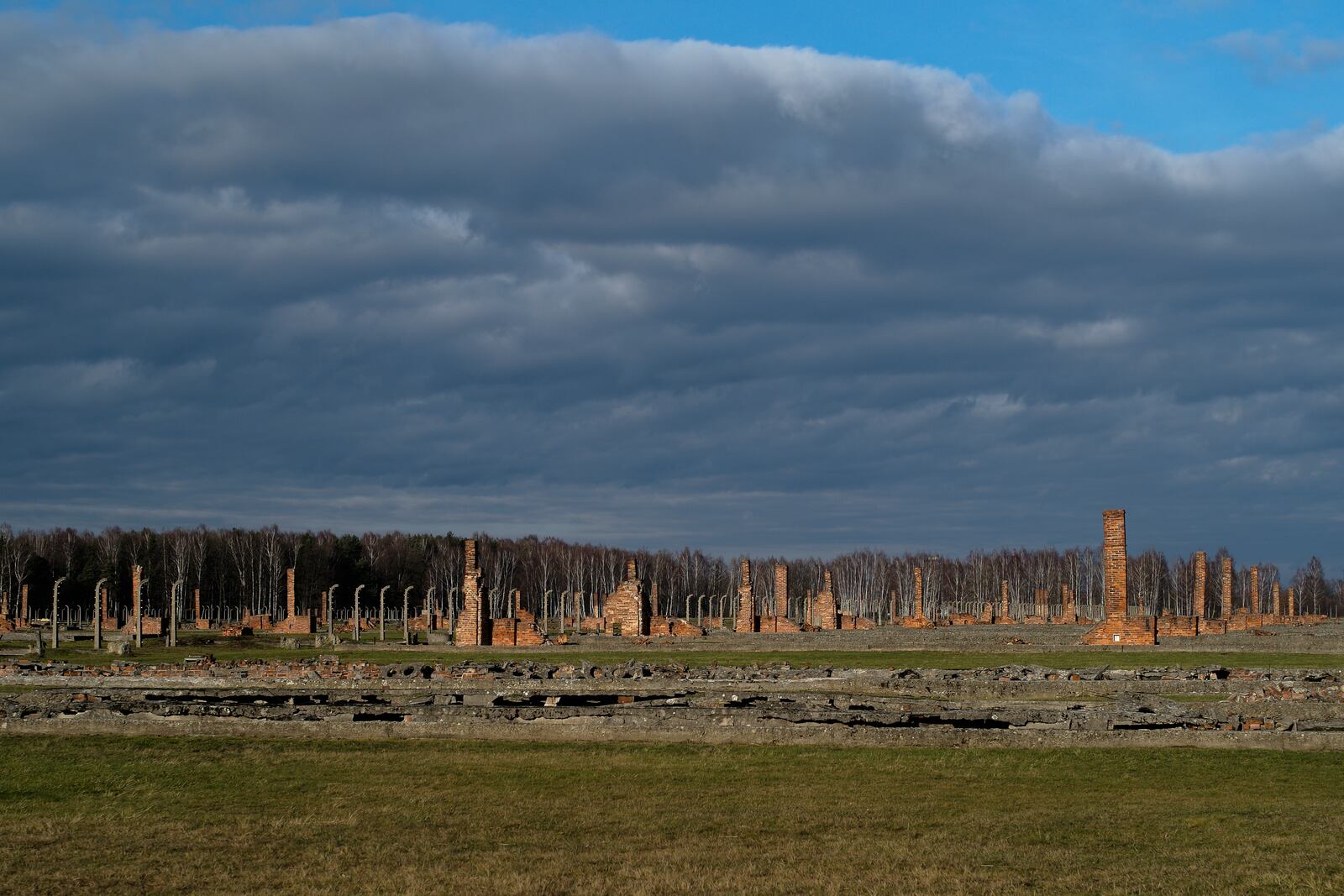 FILE — The remains of brick stone chimneys of prisoners barracks inside the former Nazi death camp of Auschwitz Birkenau or Auschwitz II. in Oswiecim, Poland, Dec. 8, 2019. (AP Photo/Markus Schreiber, File)
