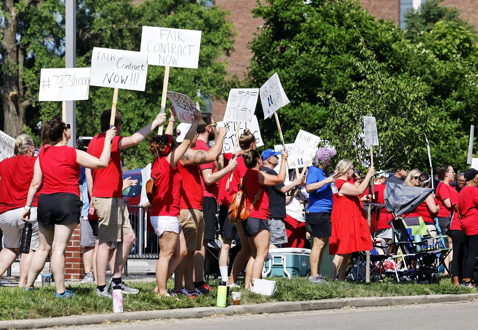 Hamilton teachers gathered along Dayton Street in front of the Hamilton City School District building to demonstrate for fair pay for teachers Wednesday, June 22, 2022. NICK GRAHAM/STAFF