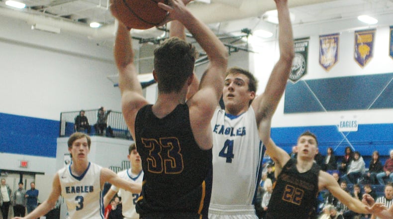 Middletown Christian’s Jeremy Lindenschmidt (4) pressures Dayton Christian’s Andrew Dreier (33) during Friday night’s game at MCS. Dayton Christian won 53-41. RICK CASSANO/STAFF
