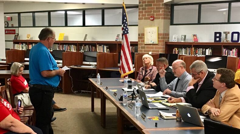 Billy Ison registers his disapproval of the Madison Schools concealed carry gun policy during a school board meeting. He has now sued the district in federal court claiming they have trampled his right to free expression.