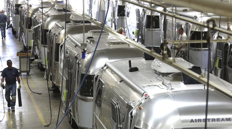 Workers check the interiors of different Airstream Trailers while they move from their placement on the chassis to the installation of the interior furniture parts at the Airstream, Inc. Factory in Jackson Center, Ohio. The trailers are world renowned for their durability and retro style. (Columbus Dispatch photo by Brooke LaValley)