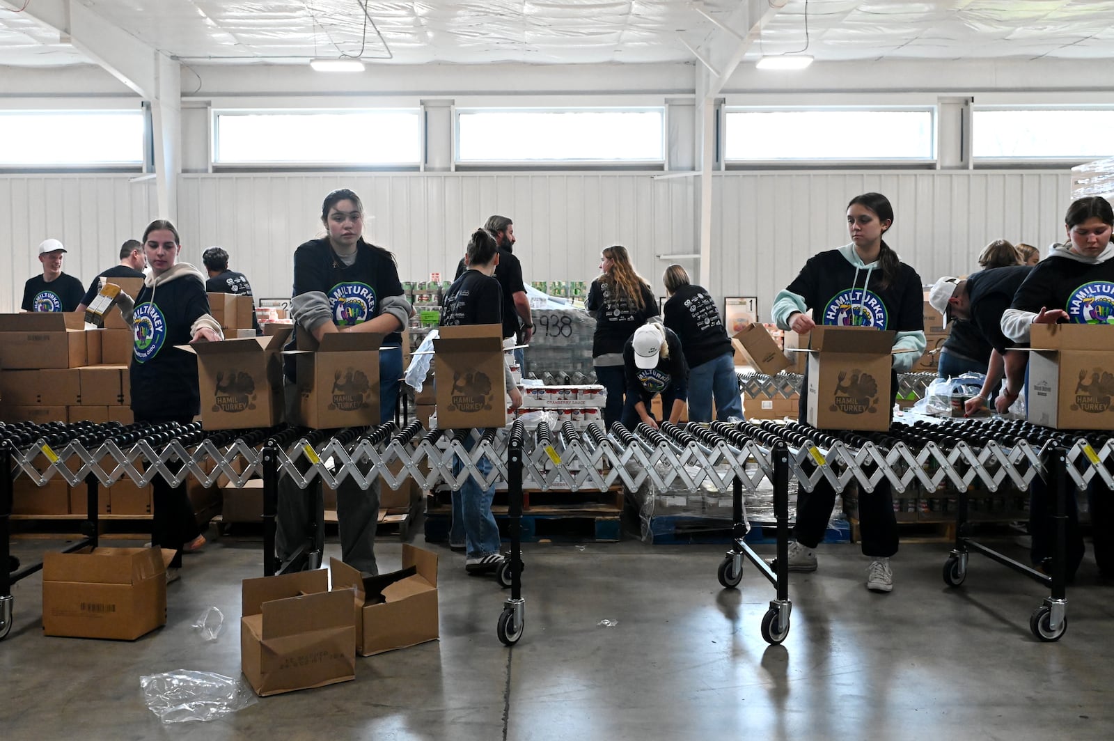Shared Harvest saw about 30 volunteers from multiple organizations pack boxes on Friday, Nov. 14, 2025, for the annual Hamil-Turkey event, where thousands of people will be fed through these prepackaged Thanksgiving dinners. Hundreds of more people are expected to be fed at a Thanksgiving buffet dinner sponsored by various organizations. MICHAEL D. PITMAN/STAFF