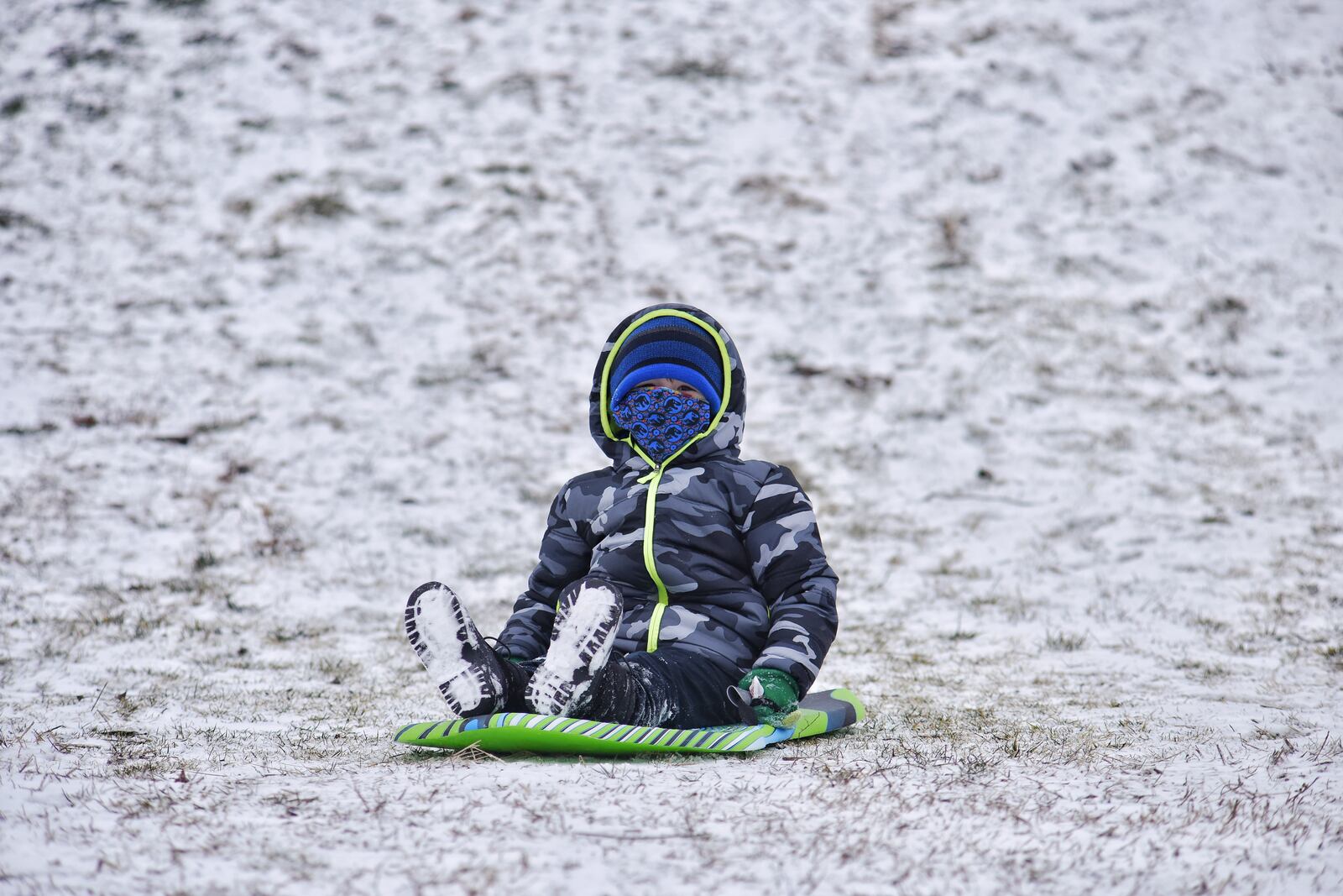 Oliver Crabtree, 4, sleds down a hill Monday, February 1, 2021. at Sunset Park in Middletown. NICK GRAHAM  / STAFF