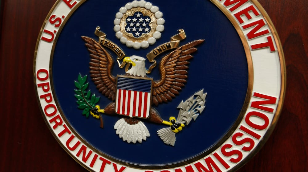 FILE - The emblem of the U.S. Equal Employment Opportunity Commission (EEOC) is displayed on a podium in Vail, Colo., Feb. 16, 2016. (AP Photo/David Zalubowski, File)